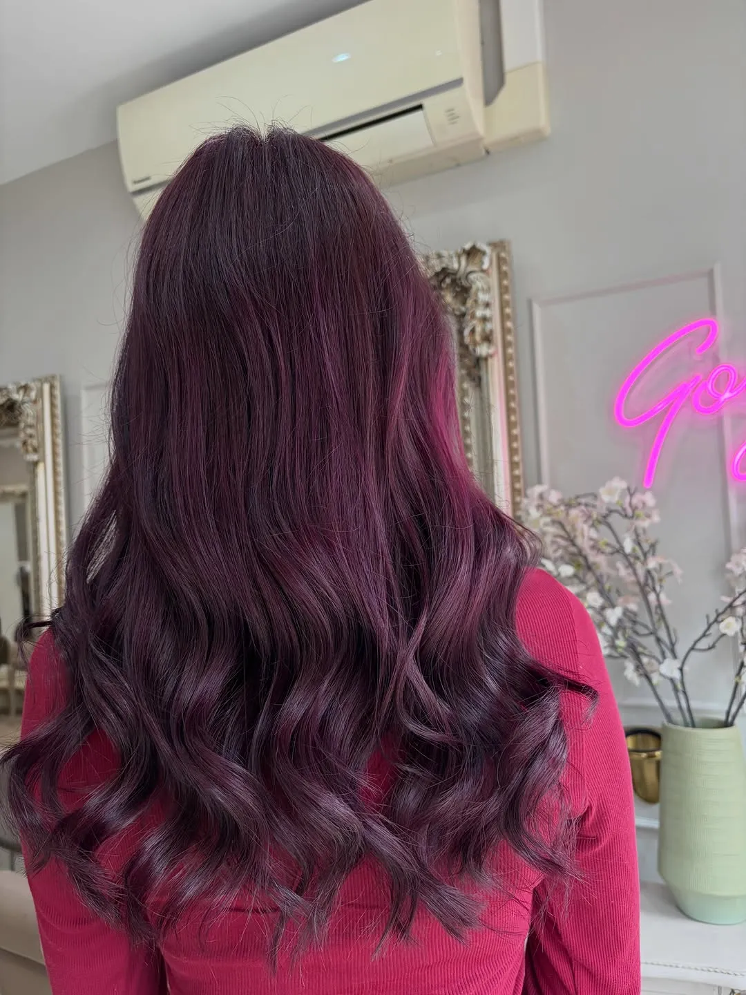 Vivid plum-purple colour in glossy long waves, coloured at The Hair Room