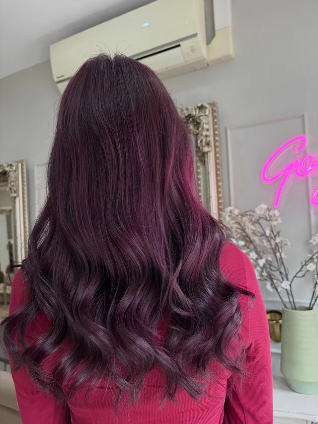 Vivid plum-purple balayage in glossy long waves