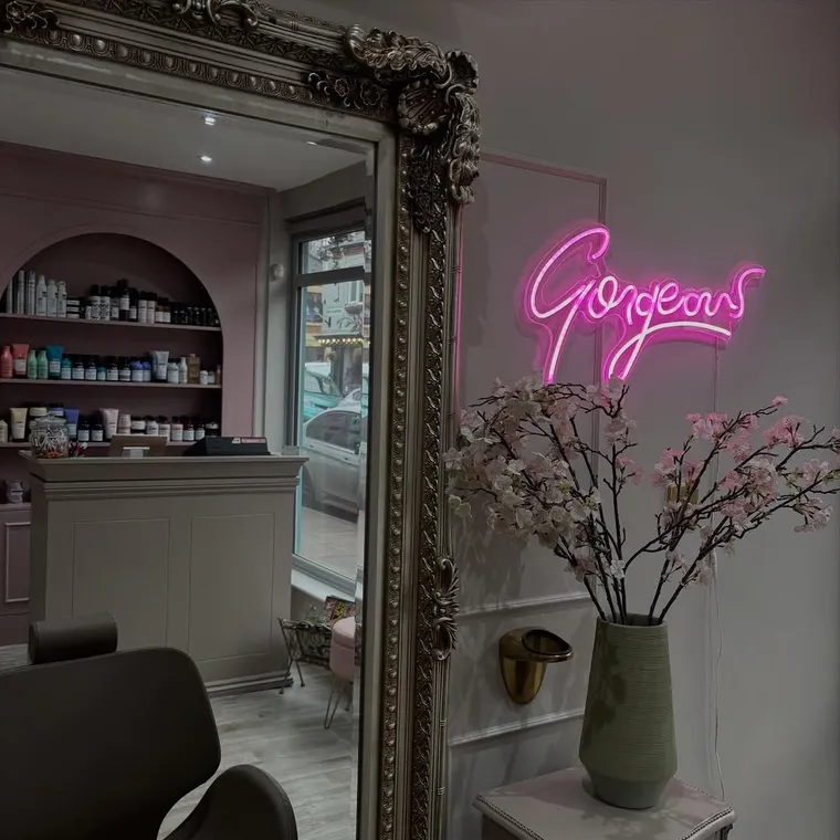 Inside The Hair Room — gilded mirror, blossom and a pink Gorgeous neon